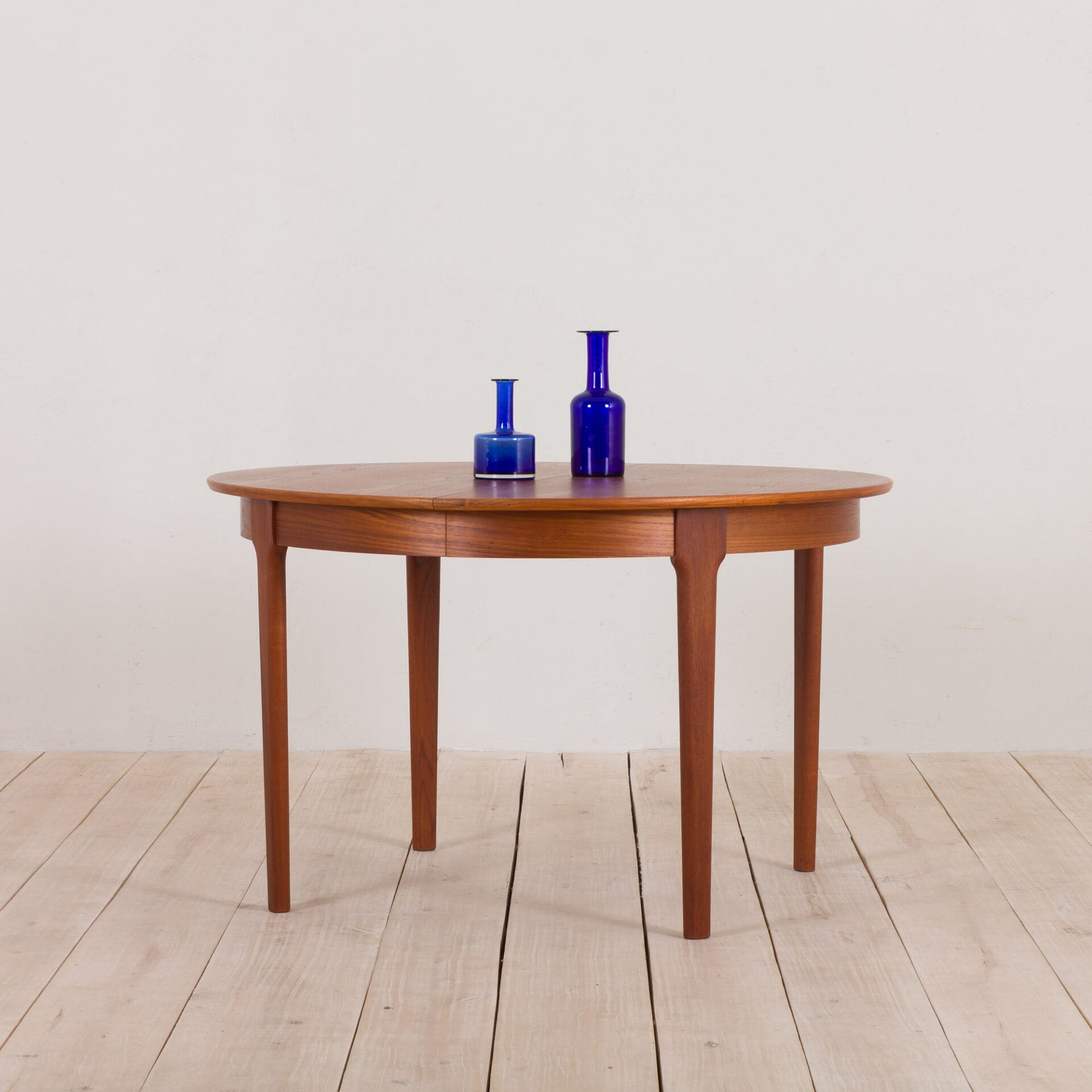 C.J. Rosengaarden teak extension round dining table with two